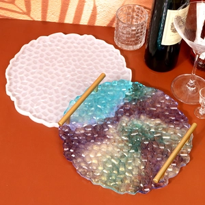 Detailed view of DIY resin tray mold with colorful geometric finished tray and gold handles