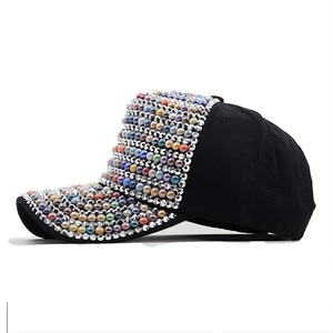 Black baseball cap with colorful rhinestones and pearls shown in a side profile view