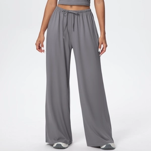 Close-up of elastic waistband and drawstring detail on grey loose fitting wide-leg pants