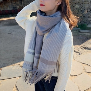 Thick grey blue and white striped knit scarf with fringe tassels for winter warmth