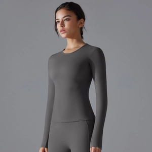 Detailed view of dark grey long-sleeve yoga top with elastic body-shaping compression fabric