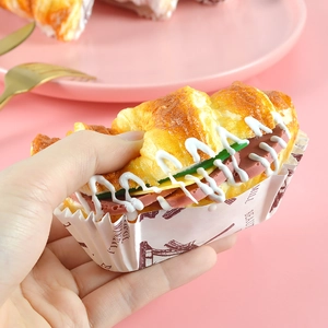 Close-up of realistic PU croissant squishy being squeezed to show soft slow-rebound texture