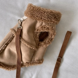 Detail of khaki suede dog harness vest with cozy lamb wool trim and metal buckles