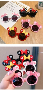 Detail view showing four colors of kids cartoon mouse ears sunglasses with polka dot bows