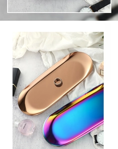 Macro detail of oval stainless steel trays in iridescent and rose gold mirror finishes