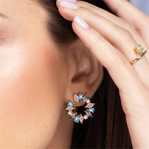 Close-up of S925 silver wreath earrings with colorful zircon stones on a model's ear
