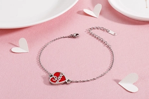 Close-up of red enamel heart pendant with Love engraving and silver adjustable chain