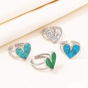 Detail of adjustable heart rings in silver steel with turquoise and marble inlays