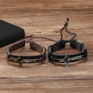 Macro view of adjustable woven leather cross bracelets in vintage brown and black styles