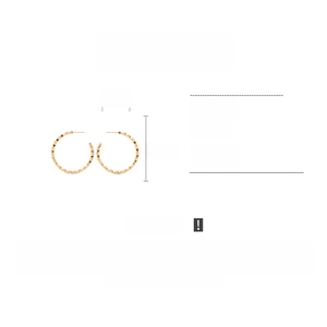 Detailed view of gold C-shaped earrings with textured geometric facets and copper specs