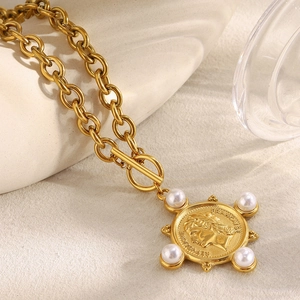 Detail of 18K gold plated coin pendant with pearl accents and OT toggle clasp on O-chain