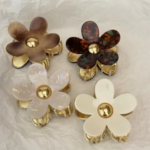 Elegant floral acetate hair claws with gold metal base in marble and tortoiseshell patterns