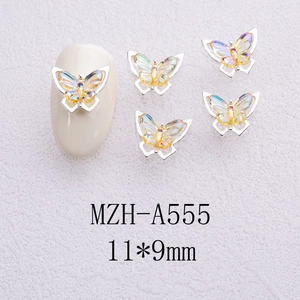 Macro shot of 11x9mm iridescent crystal butterfly nail charm on a nude nail tip