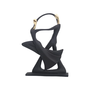 Modern abstract resin sculpture of a dancing couple in black and gold for home decor
