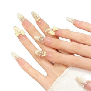 Pink nude press-on nails with 3D white bows, shimmering rhinestones and pearls