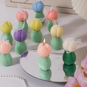 Handcrafted tulip-shaped scented candles in multiple colors with green leaf base display
