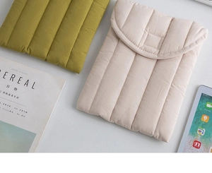 Close-up of quilted padded tablet sleeve fabric texture and protective flap detail