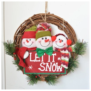 Detail of Christmas wreath with three plush snowmen and Let It Snow wooden sign