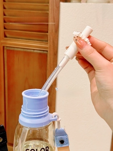 Detail of transparent portable water bottle showing smooth rim and removable straw