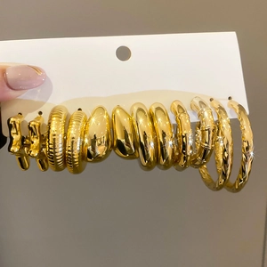 Close-up of a 6-piece vintage gold plated earring set with polished and textured designs