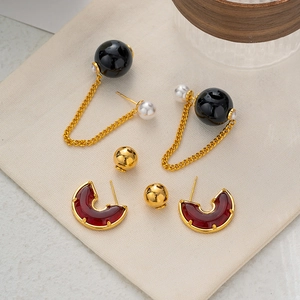 Elegant gold earrings set featuring black pearl tassels and vintage red C-shaped hoops