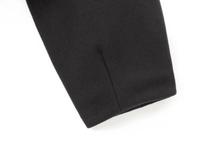 Close-up of black wool fabric texture and precision stitching on the bomber jacket cuff