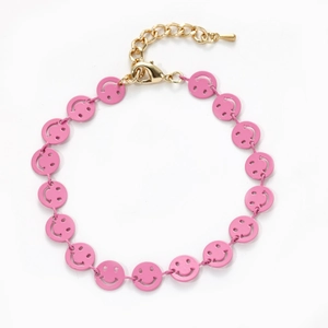 Close-up of pink enamel smiley face charm with gold plated chain and lobster clasp