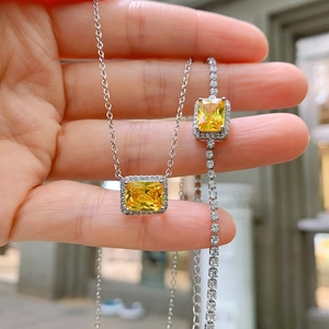 Detailed macro shot of silver jewelry set with radiant yellow rectangular gemstones