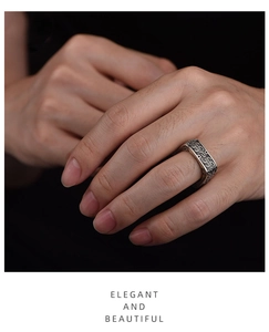 Detail shot of vintage square silver ring with intricate Chinese fretwork pattern engraving