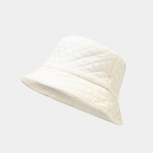 Close-up of cream faux leather bucket hat with classic quilted diamond pattern