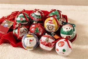 Detailed view of nine colorful coral fleece Christmas socks in transparent ball gift boxes