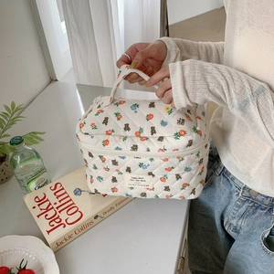 Quilted cotton makeup bag with teddy bear and flower patterns in a home setting
