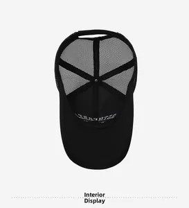 Detail view of black trucker hat interior showing mesh panel and brim embroidery