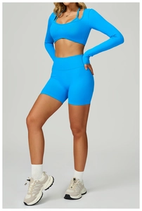 Close-up of bright blue seamless ribbed knit yoga set with cutout long sleeve top