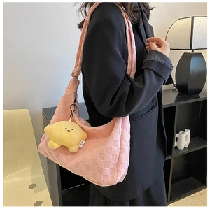 Pink checkered plush tote bag with star charm shown in a modern interior setting