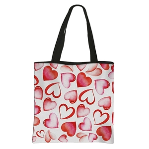 White polyester tote bag with red and pink watercolor hearts and black handles