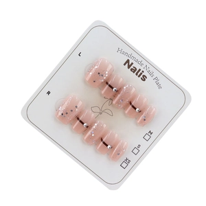 Handmade nude pink press-on nails set with glitter sequins and rhinestone accents