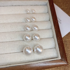 Detailed set of 5 pairs of gradient size pearl stud earrings in a velvet jewelry box