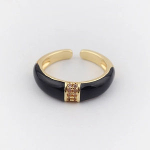 Detail of gold-plated ring featuring black enamel inlay and two rows of tiny zircons