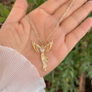 18K gold plated angel wing heart necklace with clear zircon pendant held by hand