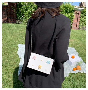 Chic white square shoulder bag with colorful floral 3D details and silver chain strap