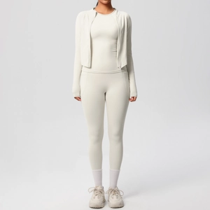 Close-up of off-white yoga set showing high-waisted leggings and slim-fit zipper jacket