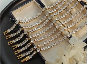 Detail of 18k gold plated tennis bracelets with sparkling cubic zirconia on jewelry box