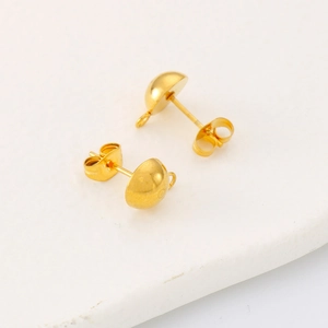 Macro detail of gold plated hemispherical stud earrings with small hanging loops for DIY