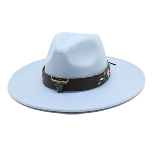 Detail of light blue felt fedora featuring bull head metal ornament and floral embroidery