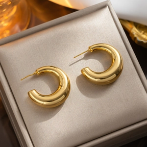 Minimalist chunky golden C-shaped hoop earrings with a polished mirror finish for women