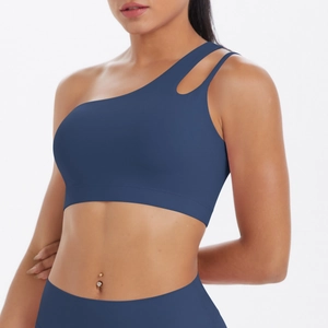 Close-up of navy blue one-shoulder sports bra with hollow detail and nylon texture