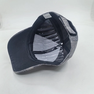Detail view of winter baseball cap interior showing 100% polyester label and grey textured fabric