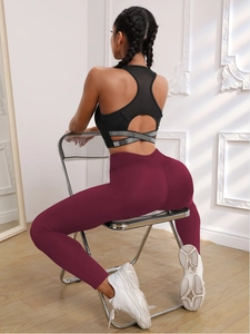 Detail of high-waist maroon yoga leggings with breathable mesh sports bra set