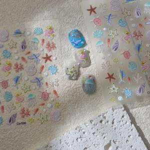 Ocean themed 5D relief nail stickers with starfish, seashells, and seahorses in gold